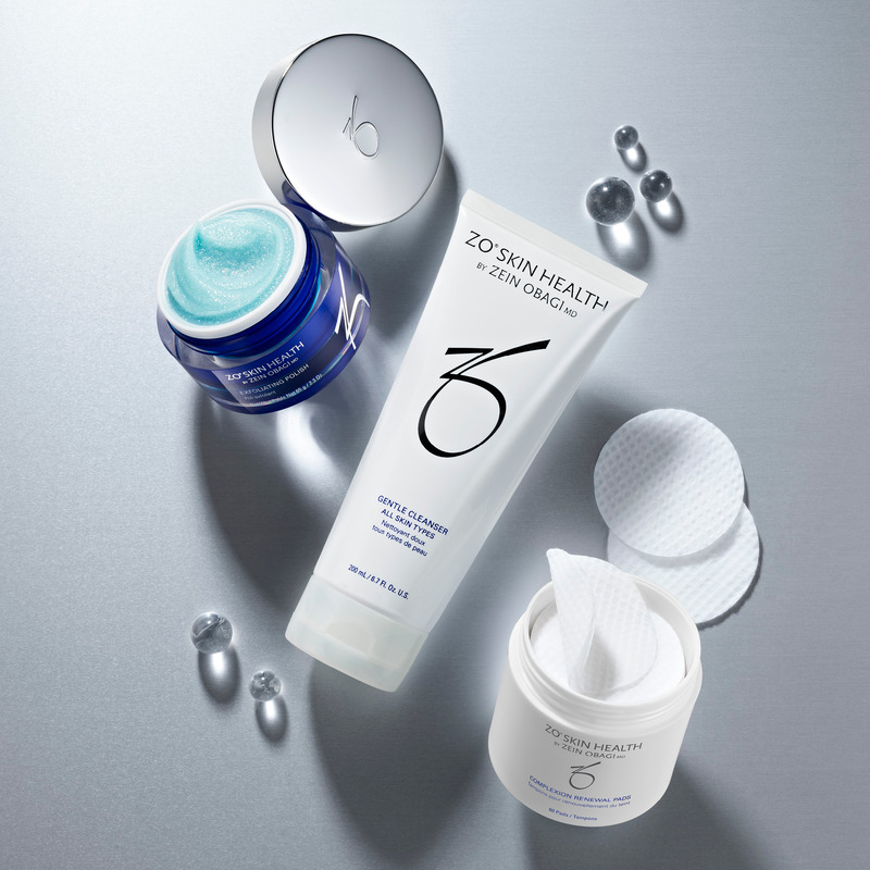 Broad-Spectrum Sunscreen, Rozatrol Accelerated Serum, Balancing Cleansing Emulsion, Hydrating Creme, Sunscreen + Powder and Sunscreen + Primer on grey/silver background